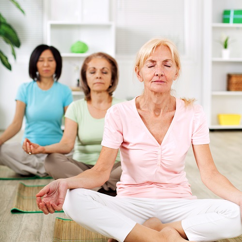 women meditating indoors