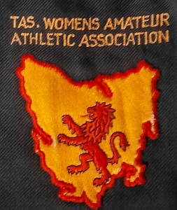 An emblem on a blazer with a map of Tasmania and the wording Tasmanian Women Amateur Athletics Association