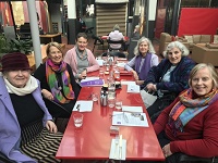 A group of women around a table.